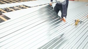 Workers putting a Metal Roof Overlay on a commercial building in Memphis, TN