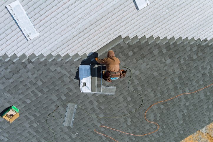 Worker installing a commercial flat roof in Corinth, Mississippi